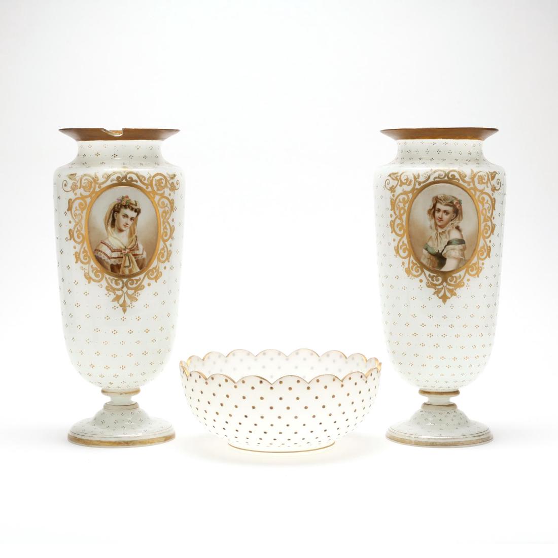 An Assembled French Opaline Glass Garniture Set: 19th century, including a pair of portrait vases with gilt decoration and a scalloped edge bowl with similar gilt decoration, all unmarked. Vases 13.75 in.; Bowl 3.5 x 8.5 in. diameter Private Collect