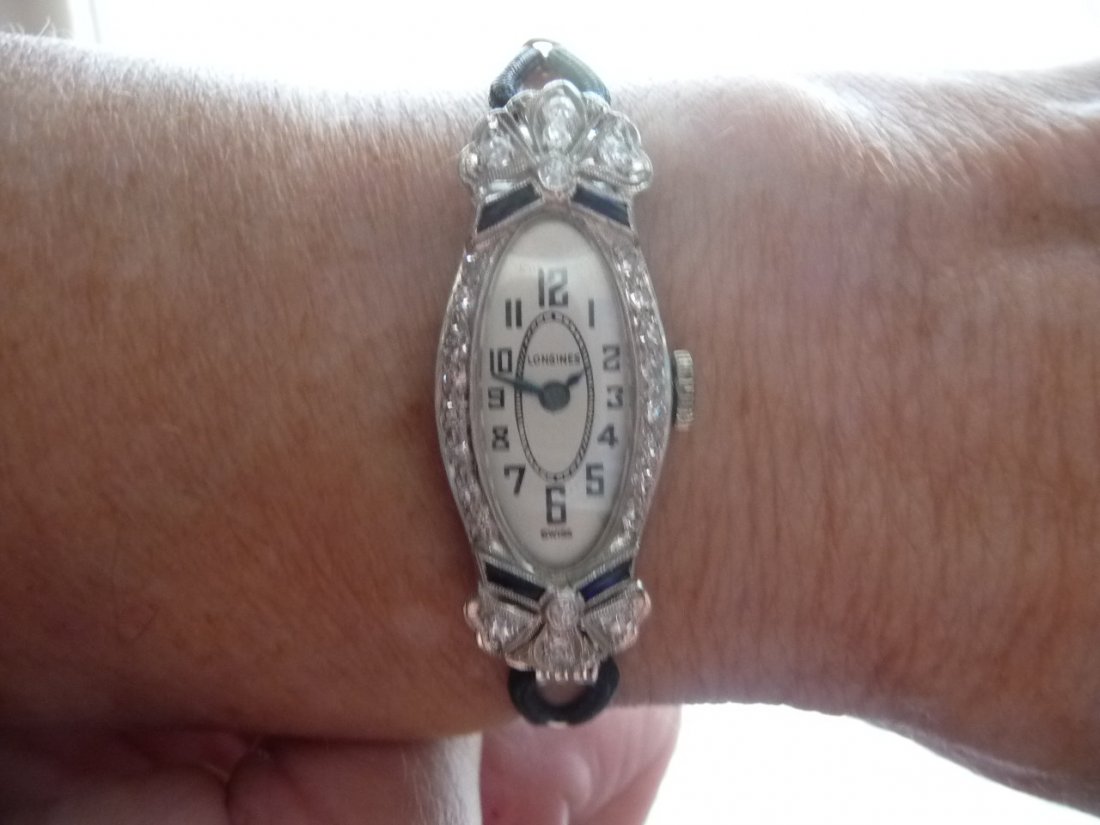 LONGINES DIAMOND & SAPPHIRE PLATINUM WATCH: LADIES LONGINES DIAMOND AND SAPPHIRE PLATINUM WATCH, AS SHOWN CASE MEASURES ABOUT 37MM LONG INCLUDING LUGS BY ABOUT 16MM WIDE INCLUDING CROWN THE LONGINES MECHANICAL MOVEMENT WAS RECENTLY SERVICED