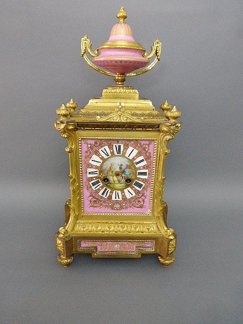 DORE BRONZE AND JEWELED SEVRES STYLE PORCELAIN CLOCK: 19th century 16” high by 8”wide. Estimated $1,200-1,500.