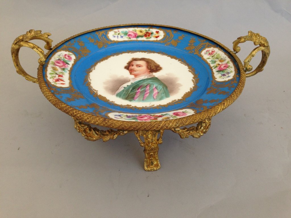 SEVRES AND ORMOLU CENTERPIECE: 19th century Sevres and ormolu centerpiece, sevres marks 1878 9.75" diameter of porcelain plate, 13' l,5.5" h Estimate $1000-1500