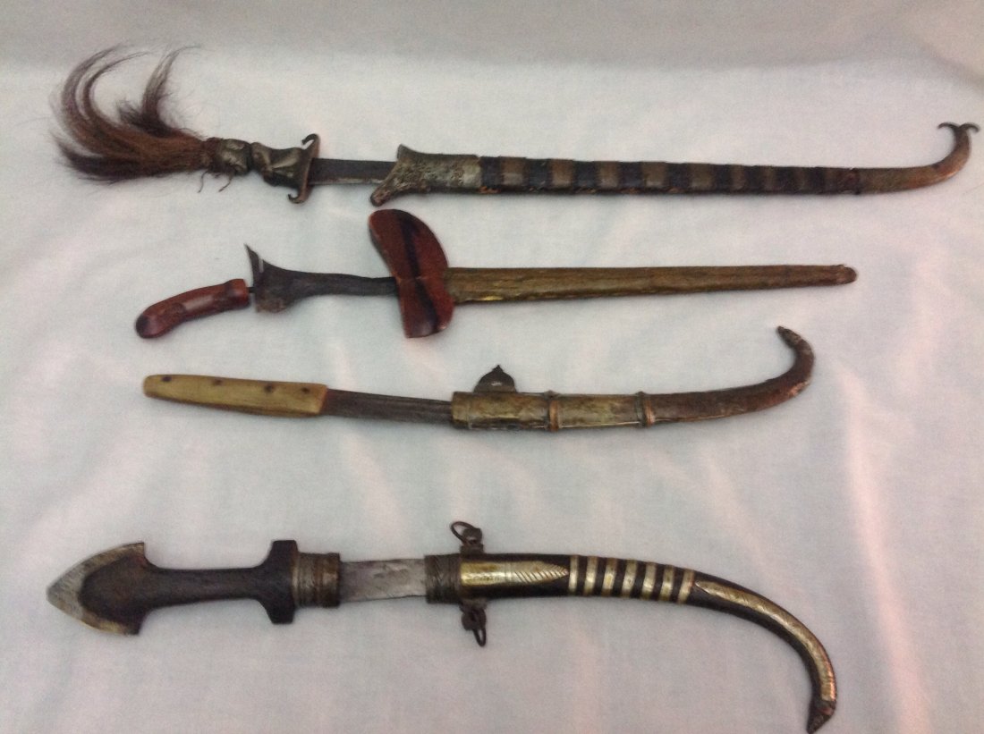 4 ANTIQUE DAGGERS: Set of 4 middle eastern daggers, 19th century. Estimate $ 300-400