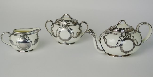 STERLING SILVER INLAID LENOX PORCELAIN TEA SET: A porcelain tea set inlaid with sterling silver. Estimate $500-800