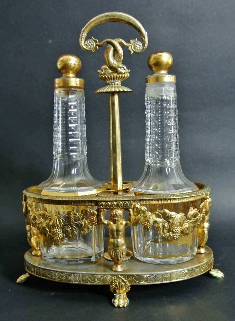 EMPIRE STYLE DORE BRONZE AND BACCARAT STYLE CRUET SET: 19th century. 11”high by 9”wide. Estimated $500-600.