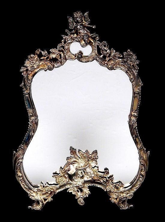 ITALIAN STERLING SILVER FIGURAL MIRROR: A sterling silver cherub figural mirror , measures 21" high , 14.5" wide , fully marked 925 . .Estimate $2.000-2.500