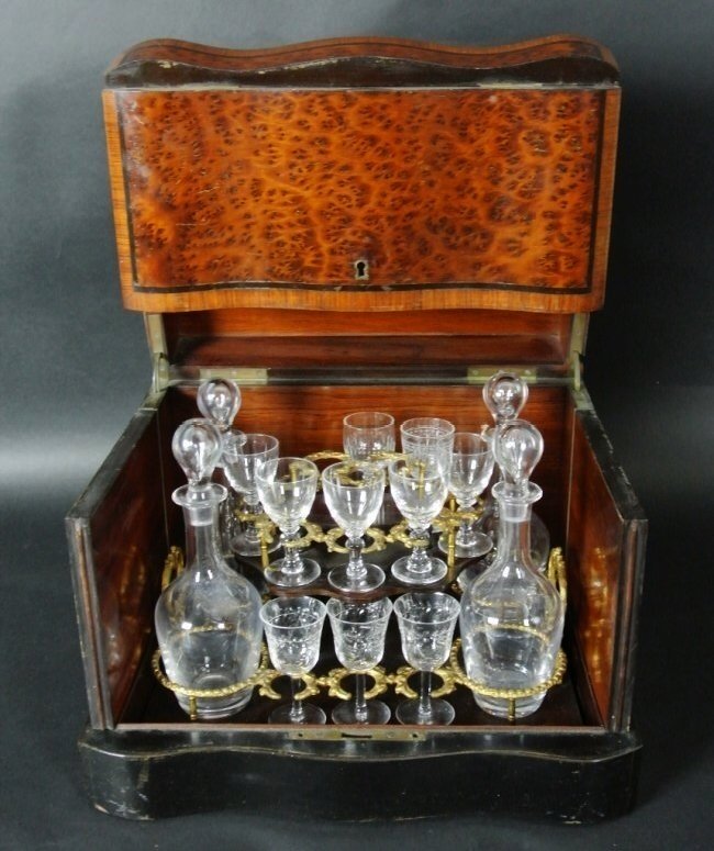 19TH CENTURY TANTALUSE: A 19th century ebony inlaid tantaluse , with glass bottles and shot glasses inside .Estimate $600-800