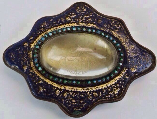 19TH CENTURY PERSIAN BELT BUCKLE WITH ISLAMIC PRAYER: A 19th century, Qadjar period rock crystal and enamel belt buckle, with a Islamic prayer carved in the rock crystal, inlaid with torquoises, 5" l, 4" w Estimate $400-500