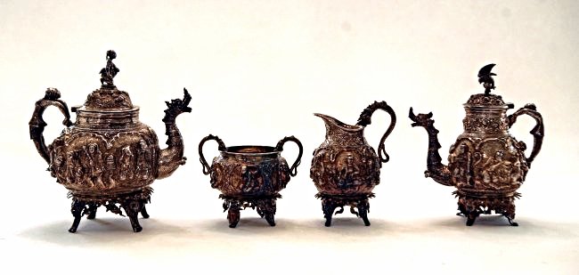 A SEINO TIBETAN SILVER TEA SET: A magnificent figural SeinoTibetan silver tea set, in excellent condition , weighing 84 oz.Estimate $3.000-4.000