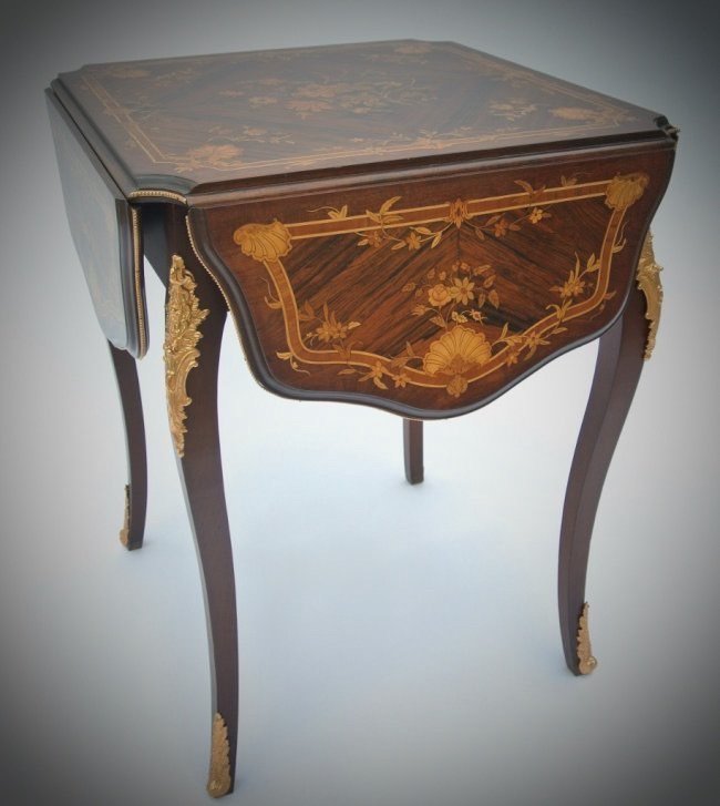 19TH CENTURY ORMOLU MOUNTED MARQUETRY TABLE: A fine 19th century Marquetry folding game table, with ormolu mounts, measures 41" l., 30" high.Estimate $1.200-1.500