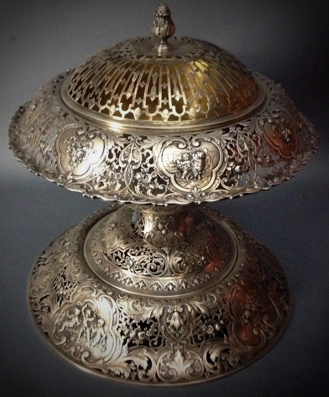 19TH CENTURY GERMAN SILVER CENTERPIECE: Large 19th century reticulated German silver centerpiece ,marked 800. 16" h, 15" diameter. Weighs over 3250 grams Estimate $6000-7000