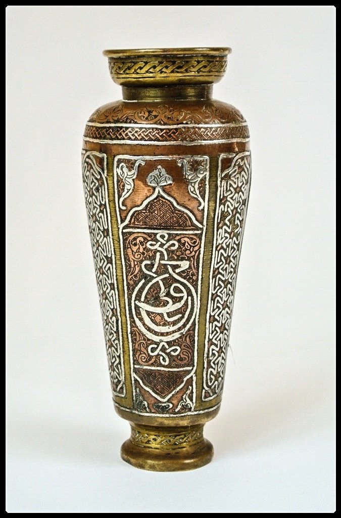 ANTIQUE ISLAMIC SILVER AND COPPER INLAID VASE: 7" high. Estimate $300-400