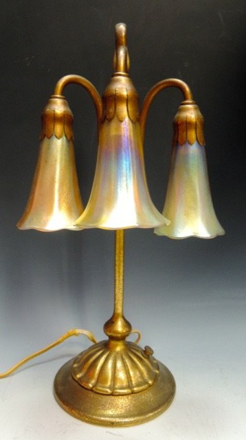 TIFFANY STUDIOS LAMP: Signed Tiffany Studios, New York 3 Lite lamp. Dore Bronze base signed Tiffany Studios, New York # 306. 16 1/2” tall. Each shade is signed L.C.T. (authentic) . Estimate $4.000-4.500