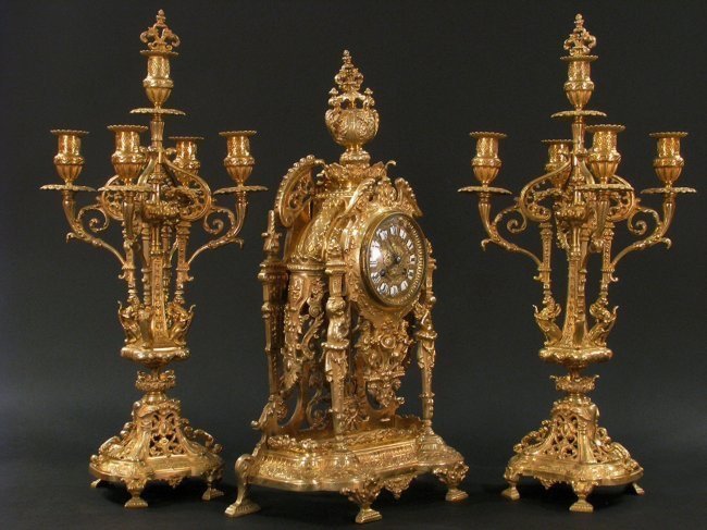 19TH CENTURY GILT BRONZE CLOCK GARNITURE: A very fine 19th century century ormolu clock set , Candelabra 23 inches , Clock 21’.5" .Estimate $2.000-2.500