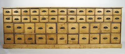 Huge 48 drawer Pine 19thC. Apothecary 9 Ft. Chest: Pine 19th Century 48 drawer Apothecary Chest with 26 small drawers over 22 larger drawers with cast iron embossed handles. The drawers are constructed of old early soap boxes which still have lithogra
