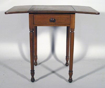 Sheraton 19th C. Walnut Mahogany Drop Leaf Table: Sheraton 19 C. walnut mahogany one drawer drop leaf table has turned legs with curved ends and turned wood knob. In good condition. Measures 28 ¾" high, 18 ¼" wide and 21 ¾" deep. With the drop lea