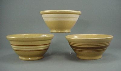 Early Antique Yellow Ware Yelloware Bowl s (3): A three piece lot of yellow ware bowls that are similar in size. One bowl has two brown and two white bands in good condition with only light wear from normal use; another bowl has two wide white band