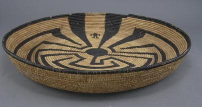 Pima Native American Indian Man in Maze Basket: Pima Native American Indian Man in Maze Basket is round with a 2 ½"high edge. The decoration is painted on the basket and not woven into the design. In very good condition. 15"d.