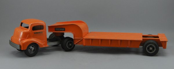 Smith-Miller Fruehauf 26" Toy Truck Original Paint: Smith-Miller Fruehauf GMC Cabover Lowboy Machinery Hauler.The lowboy machinery hauler has most of the original paint and seems to be complete. Measures 5 ½" high and 26" long.