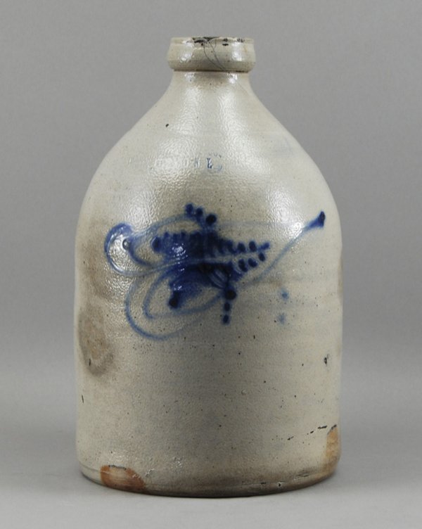 Ottman NY 19C Stoneware Crock Jug w Leaf Decoratio: American 19C Blue Wash Stoneware Ottman N.Y. Jug. The Ottman & Co., Fort Edward, N.Y. blue wash jug has a leaf design on the front and manufacturer's embossed name as well. There is a tight crack from