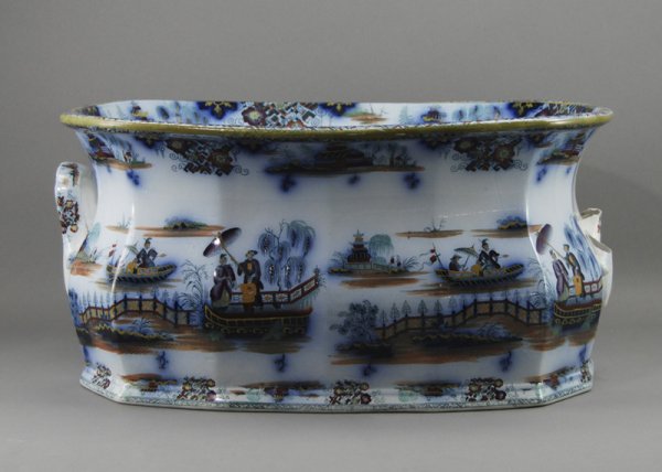 Flow Blue Mid-19C. Oriental Design 18" Footbath: Early mid-19th century Flow Blue "Oriental" design footbath. The large oriental patterned polychrome footbath has a rich flow blue decoration. In good overall condition. Has a tight hairline crack and
