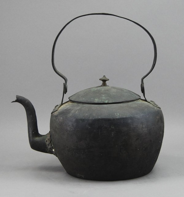 Early 19C American Copper Tea Pot Kettle: Early 19C American Copper Tea Kettle. The early copper tea kettle has a folding swing handle. It is in good condition except that there is a poorly soldered repair on the neck. Measures 11 ½" high.