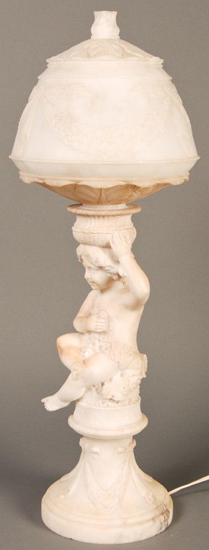 Antique Carved 19C Alabaster Putti 23" Lamp & Shade: Carved 19th or early 20th century Italian alabaster putti lamp. The decorative figural lamp, has a garland and bow tied alabaster carved shade and base with a stem of a carved putti embellished with g