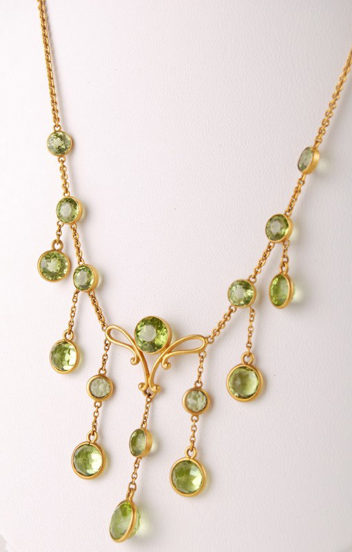 Art Nouveau 14K Gold Peridot Necklace: Art Nouveau 14K Gold Peridot Necklace. The necklace has 17 round faceted Peridots. In good condition. The old replaced barrel clasp is gold filled. Unsigned and assayed to be 14K. Weighs 5.9 dwt.