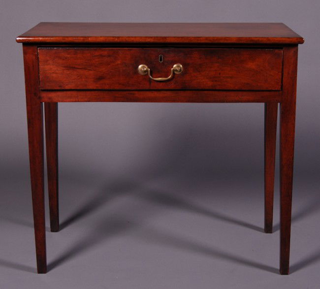 English Mahogany Early 19C One Drawer Side Table: English Early 19C Mahogany 1 Drawer Side Table. Has tapering legs with a 1 board mahogany top. Original hardware and lock. Good condition. Measures 29" high x 31 ¾" wide x 16" deep.