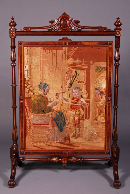Walnut 19C Adjustable Hmade Needlepoint Firescreen: Walnut 19th century carved and gilt adjustable fire screen. The original handmade and still vibrant colored needlepoint depicts a women knitting with a young boy waiting to go play with his friends. T