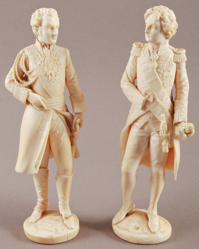 Two Fine French 19C Carved Ivory Officers Statues: Two European 19th century ivory carvings of gentlemen officers. The two finely carved French ivory officers are both wearing full dress clothing with medals. Both figures lack the ends of the bottom h