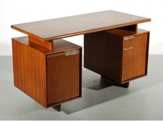 Gilbert Rhode Herman Miller Walnut Art Deco Desk: The Gilbert Rohde designed walnut desk was manufactured by Herman Miller, model # 3977 circa 1939. The desk has the original Lucite handles and the desk still retains the original finish and is good o