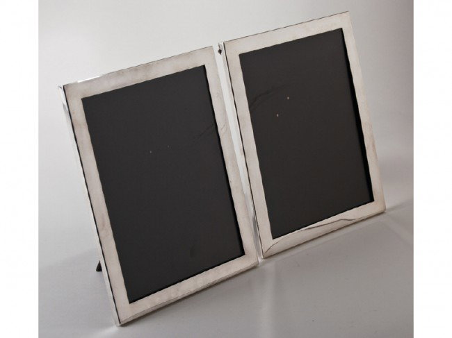 Pair of Tiffany Sterling Silver 8x10 Picture Frames: Pair of Tiffany sterling silver frames have black bakelite easel backs. In good condition with light wear from normal use. Marked Tiffany & Co. Sterling Silver Makers. No monogram. Measures 10 3/4" x