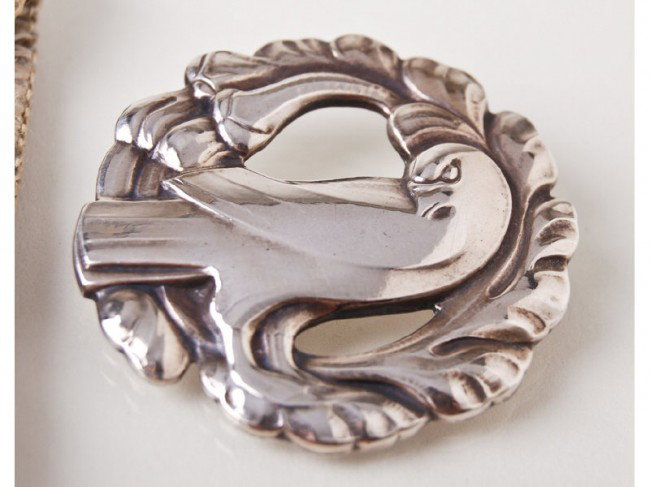 Two Georg Jensen Sterling Bird Chrysoprase Pins: Two George Jensen Sterling Pins, consist of a dove pin which is missing the original pin closer and is marked with the George Jenson mark, Sterling Denmark #165. The other pin has a Cabachon Chrysopra