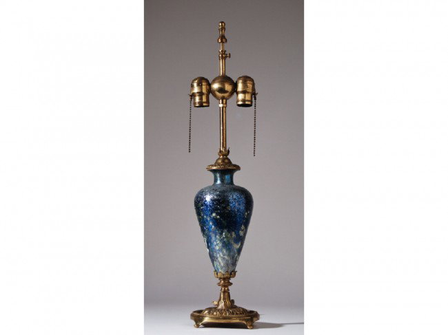Tiffany Studios Cypriote Favrile Art Glass Lamp: The circa 1900, tear drop form blue Tiffany Favrile Cypriote glass is mounted with a baluster form brass base with embossed acanthus leaves and garlands. The Cypriot glass is engraved Louis C. Tiffany