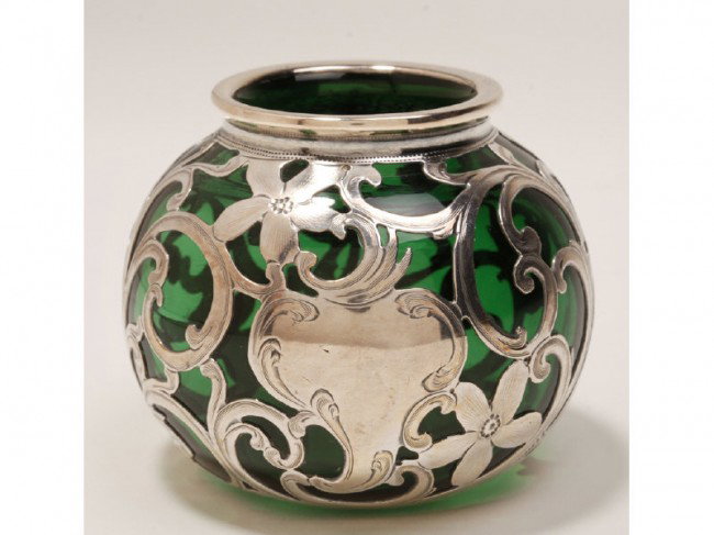 Art Nouveau Sterling Silver Overlay Green Vase: Art Nouveau green glass ball-form cabinet vase with decorative sterling silver floral overlay. In good condition. Hallmarked on the silver and measures 2 ½" high x 3" in diameter.