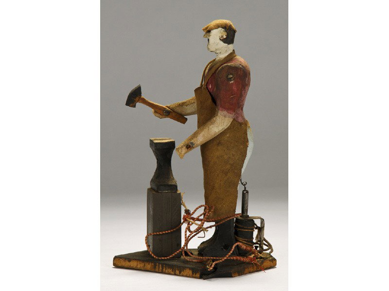Folk Art Toy Homemade Blacksmith and Anvil: Folk Art Homemade Blacksmith and Anvil Original Paint Toy. The homemade carved wooden hand painted folk art blacksmith toy, is set up for battery operation. It is in overall good condition. It has the