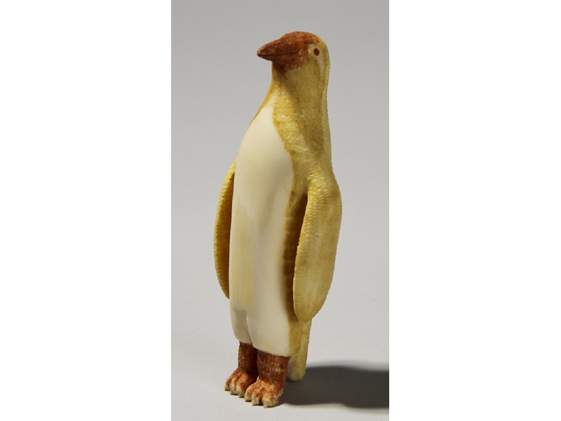 Carved Inuit Indian - Painted Whale Bone Penguin: Old Carved Inuit Native American Indian Painted Whale Bone Penguin. The carved penguin has a stained yellow and red coloration with a cross hatched carving on the back with a smooth chest and belly. I
