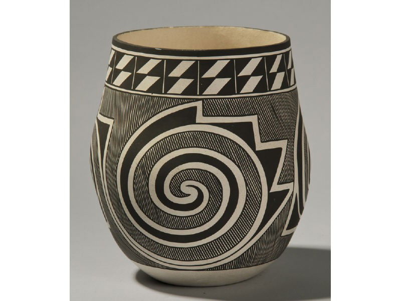 Signed M. Sarracino - Laguna Pueblo Pottery Jar: Laguna Pueblo Native American Indian Pottery Jar by M. Sarracino. The black and white thin walled pottery jar has a spiral decoration along the body with stripes. Signed on the base "M. Sarracino Lagu