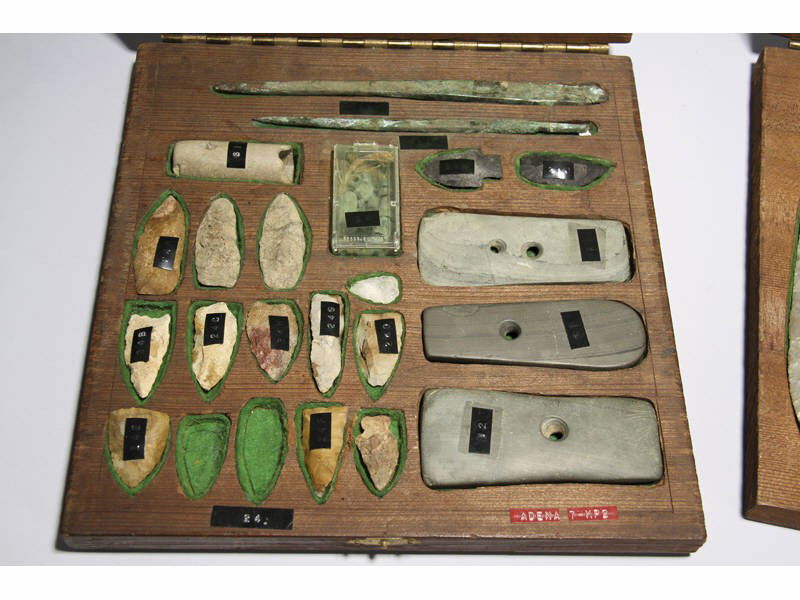 Collection Adena Indian Arrow Heads and Artifacts: Collection of Adena Native American Indian Arrow Heads and Artifacts. 1 of 3 folky boxes, which are inlaid brass profile of an Indian head that contains various arrow heads and gorgets. Also included