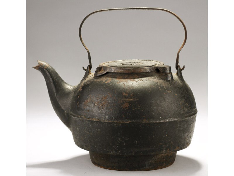 Cast Iron 19C Tea Kettle with Makers Monogram: Cast Iron 19th Century Tea Kettle with Makers Monogram. The cast iron tea kettle has an embossed makers monogram at the top and is made to fit into a wood stove. The swing out lid is in good operating