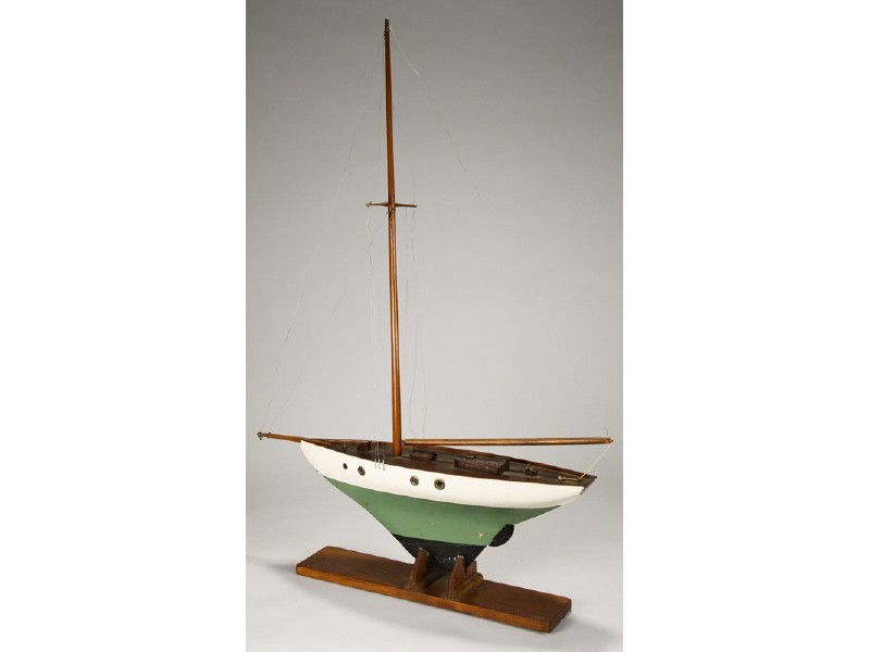 Painted 1920's Marine Nautical 40" Pond Sail Boat: Old 1920s Wooden Green, White and Black Single Mast Pond Sail Boat. The old wooden toy model boat has a dark-wood deck with covers and hatches. There is one missing brass porthole cover. The bottom of