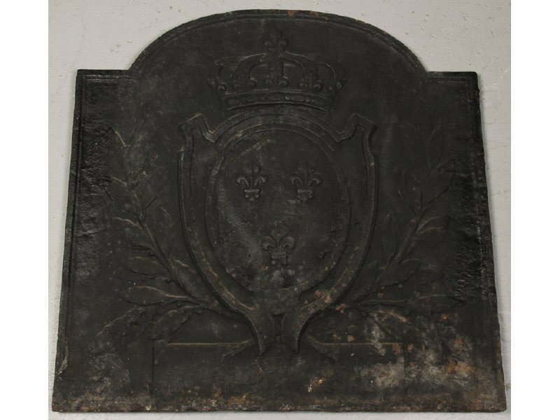 Cast Iron 19C French Tombstone Shaped Fireback: Cast Iron 19th Century Tombstone Shaped Fireback. The antique cast iron fireplace back has a medallion, surrounded by leaves, and a crown at the top. The tombstone is possibly French. Weighs 70 pounds