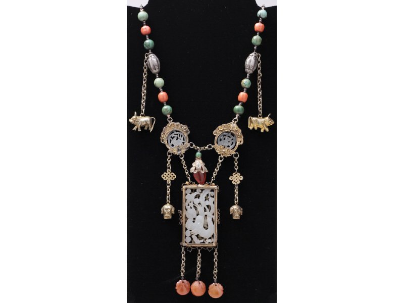 Chinese Carved Jade Carnelian Turquoise Necklace: Chinese Carved Jade Carnelian Turquoise Silver Necklace. The unusually designed necklace has a light green jade dragon carved rectangular pendant flanked by two round jade pieces, one carved with a fo