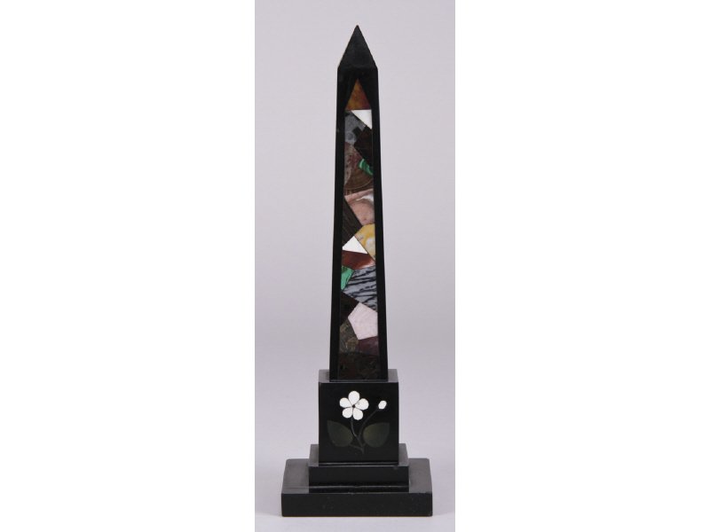 Pietra Dura 19C Specimen Marble Inlaid Obelisk: The Pietra Dura 19th Century specimen black marble obelisk is inlaid with various colorful cut marble specimens with inlaid marble flowers and leaves at the base. In good condition with a few miniscul