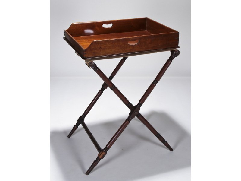 English 19C Mahogany Butlers Tray and Stand: English 19th Century Mahogany Butler's Tray and Stand. The 19th century folding turned leg stand shows some wear and scuffing. The handled mahogany dovetailed butler's tray has an old tight and short 