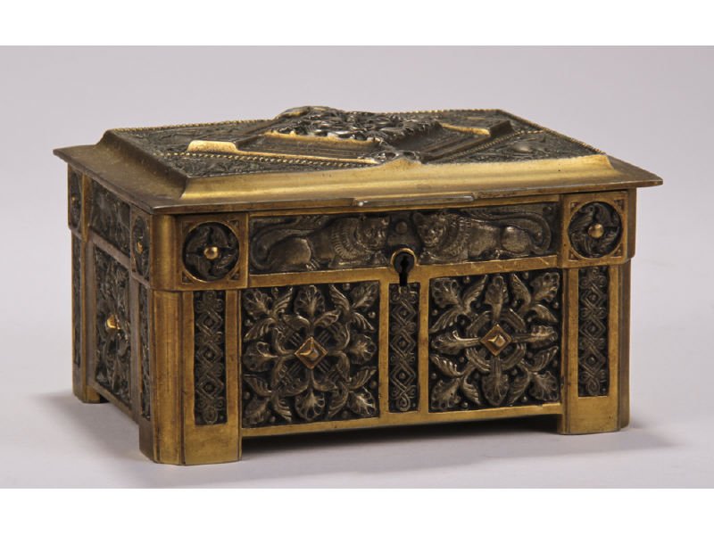 Brass 19C Syrian or Babylonian Design Jewelry Box: The cast brass and gilt box has relief decoration of two Syrian or Babylonian lions on the front with exotic birds as well. Retains the original velvet lift out insert and lining. The underside is sig