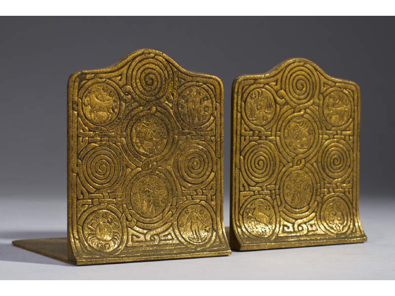 Pair of Tiffany Studios NY Zodiac Bronze Bookends: Pair of Tiffany Studios NY Zodiac Bronze Bookends. Bronze Tiffany bookends with gilt patina. Signed on the base, 'TIFFANY STUDIOS NEW YORK 1091.' In good condition with light wear from normal use. Mea