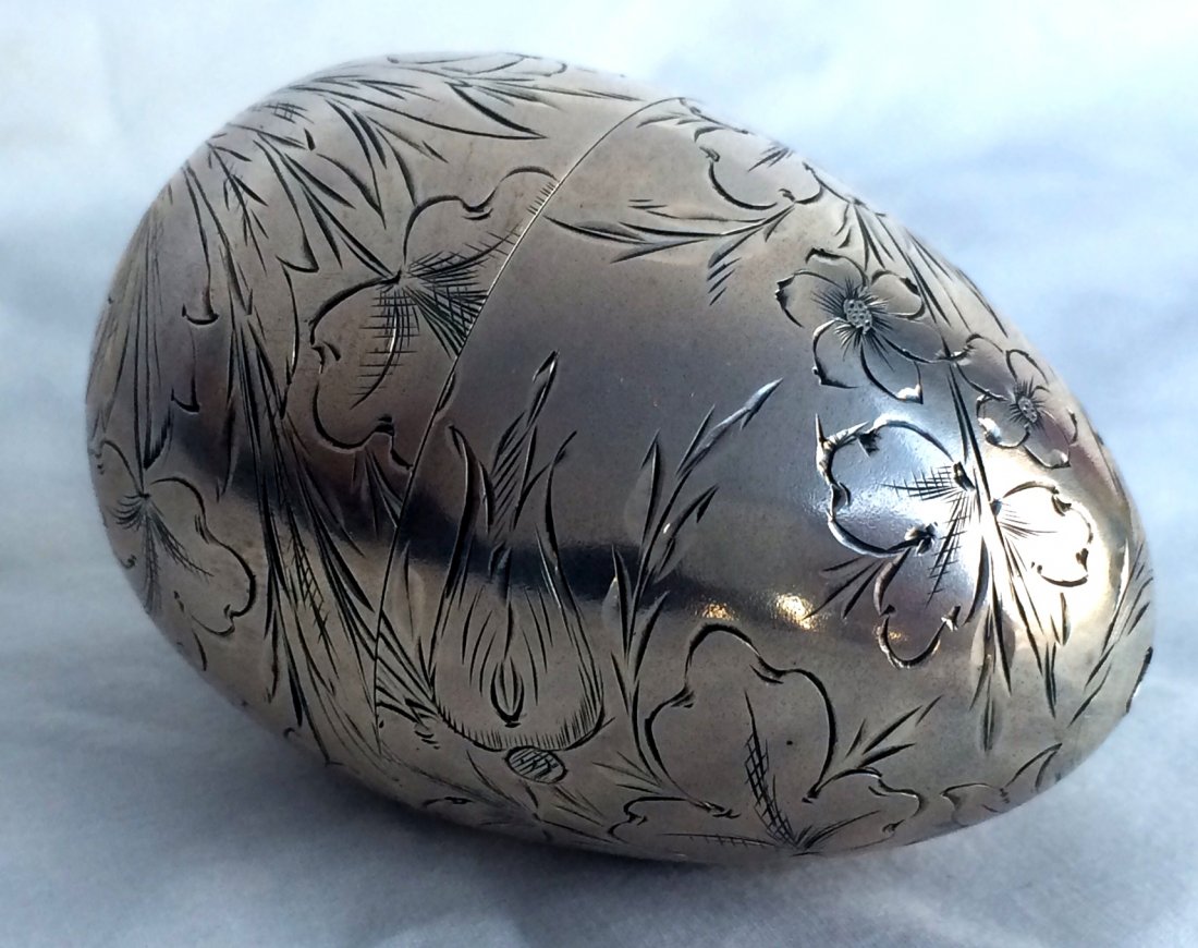 Engraved Russian .84 Silver Convertible Easter Egg: Engraved Russian .84 Silver Convertible Easter Egg. The Russian coin silver egg has a chased floral decoration. The egg disassembles and can be converted into either two egg cups or small goblets. Eac