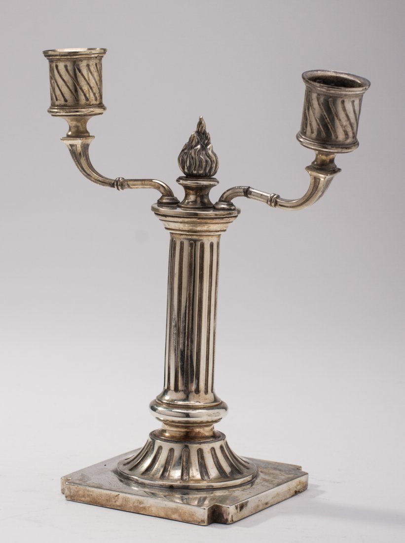 Russian 19C Coin Silver .84 Two Arm Candelabra: Russian .84 Coin Silver Two Arm Candelabra. The weighted Russian candelabra is marked 84 and dated 1892 with makers mark KA on the base. The pillar form candelabra with a flame finial rests on a cut c