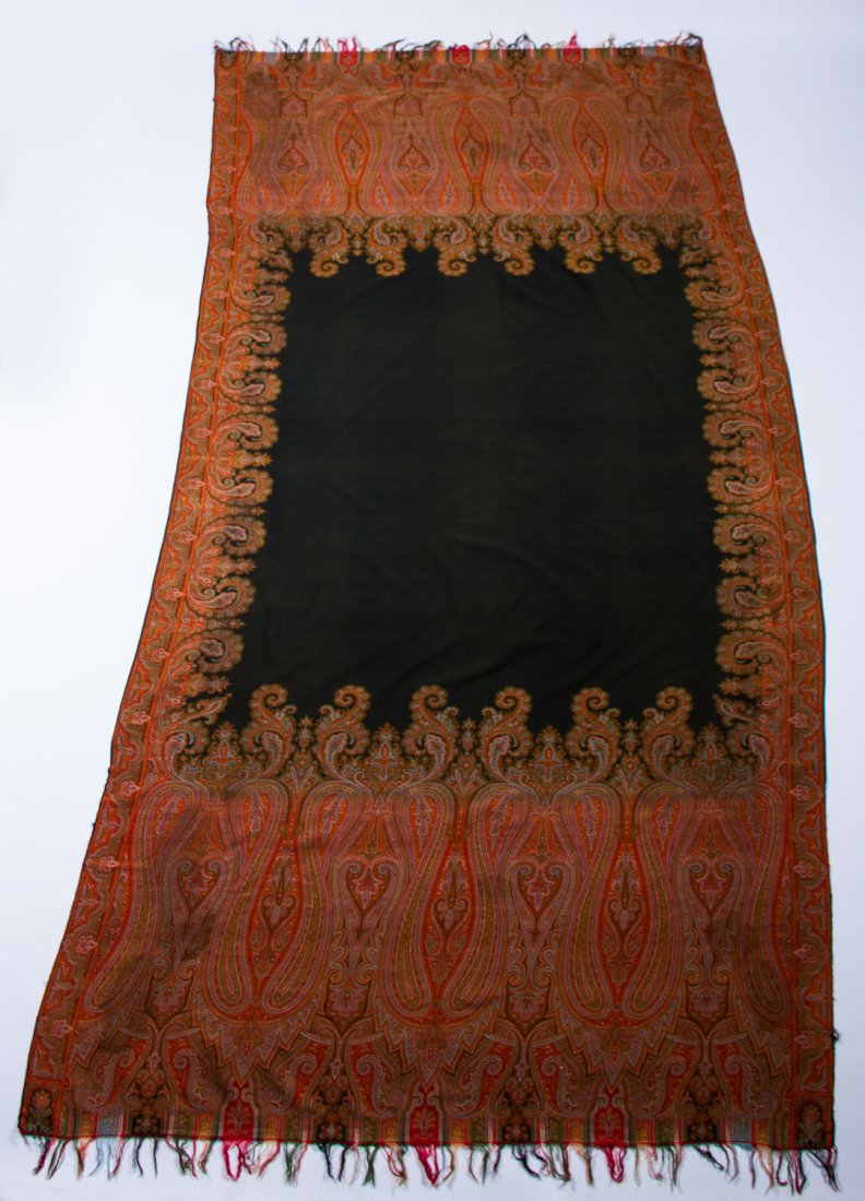 Paisley 19C Handwoven Long Piano Shawl 10 ft x 5 ft: Pailey 19C Hand Woven Long Piano Shawl. The elaborate handwoven 19th century Kashmir paisley pattern shawl has a black center and multicolored fringe. In good condition, retains the original vibrant r