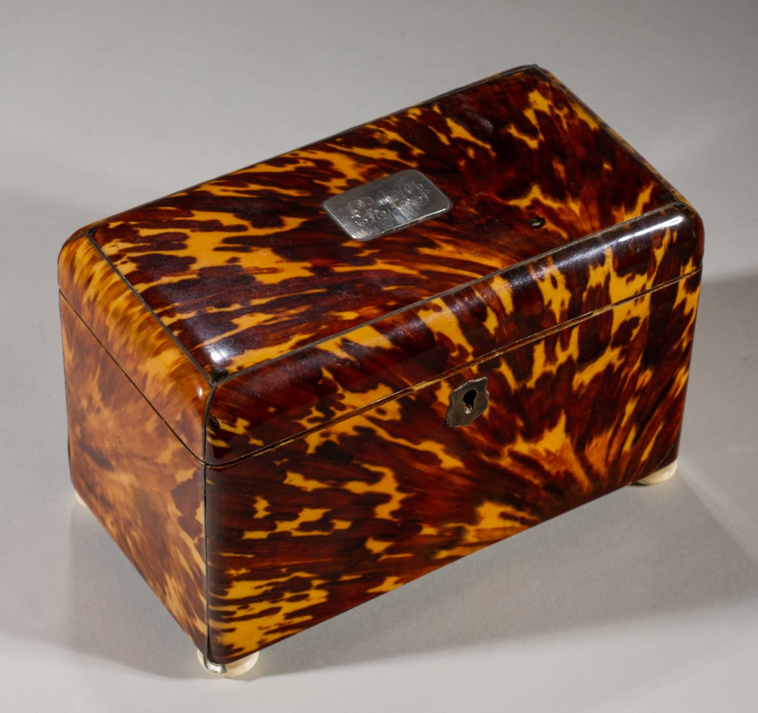 English 19C Tortoise Shell & Ivory Footed Tea Caddy: English 19C Tortoise Shell Tea Caddy. The fine period 19th century tea caddy has a decorative sterling cartouche on the top with a period engraved monogram and a sterling escutcheon. The caddy is rais